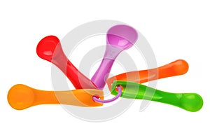 Multicolored plastic measuring spoons in grams photo