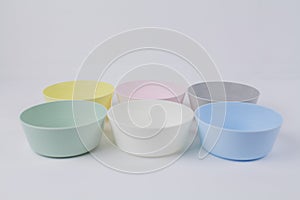 Multicolored plastic plates on a white background