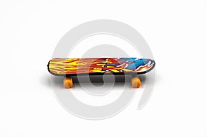 Multicolored plastic skateboard on a white background. children's toy