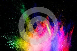 Multicolored powder explosion on black background.Abstract colorful dust particles textured background