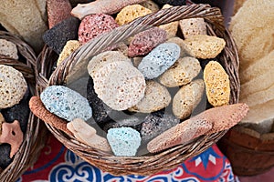 Multicolored pumice stones in the wicker basket at the market in Egypt.
