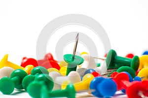 Multicolored push pins on awhite background close-up macro, place for text
