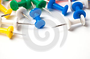 Multicolored push pins on awhite background close-up macro, place for text