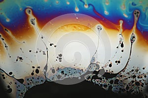 Multicolored rainbow soap bubble, psychedelic background. Abstract liquid colors and texture