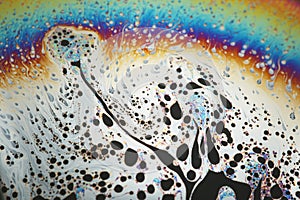 Multicolored rainbow soap bubble, psychedelic background. Abstract liquid colors and texture