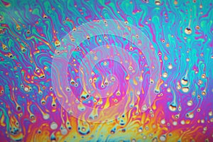 Multicolored rainbow soap bubble, psychedelic background. Abstract liquid colors and texture