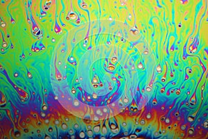 Multicolored rainbow soap bubble, psychedelic background. Abstract liquid colors and texture