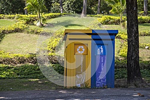 Multicolored recycling bins in the park. Outdoor garbage containers for plastic, paper, glass. Sustainable lifestyle concept. Blue