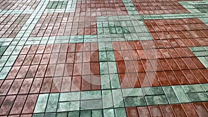 Multicolored red and gray tiles on the floor in rows and patterns. Background, texture, pattern, place for text