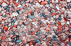 Multicolored round pebbles on the beach. Beautiful background