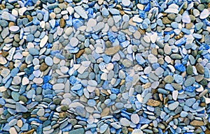 Multicolored round pebbles on the beach. Beautiful background