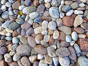 Multicolored round stones pebbles background