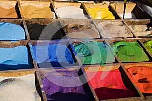 Multicolored sand in the boxes