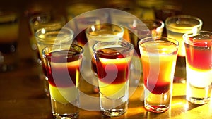 Multicolored shots on the bar.