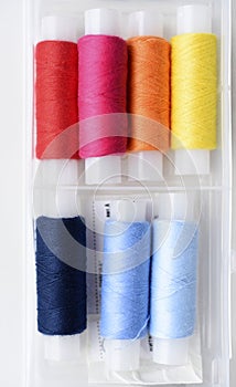 Multicolored skeins of thread in the set. The threads are in a plastic box