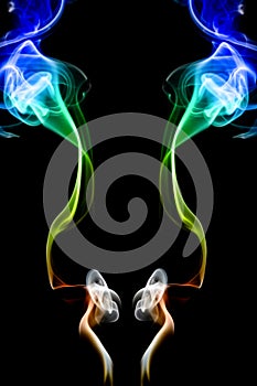 Multicolored smoke of green and blue colors on a black isolated background. Background of blurry smoke effect
