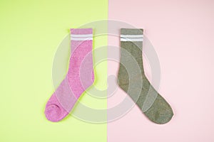 Multicolored socks on a pastel multi-colored pink and green background