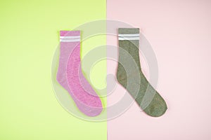 Multicolored socks on a pastel multi-colored pink and green background