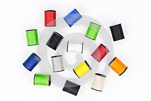 Multicolored spools of thread on white background horizontal com