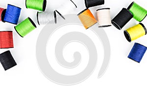 Multicolored spools of thread on white background horizontal com