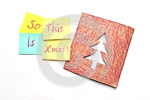 Multicolored sticky notes with christmas theme and a card over a white background