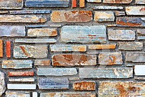 Multicolored stone multifaceted mosaic sandstone texture closeup