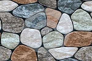 multicolored stone with rounded faces wall background.