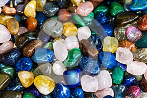 Multicolored stones. Semi-precious stones, crystals and other minerals, displayed for sale in a fair