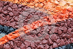 Multicolored stones. The wall is painted in different colors in texture style. Grunge background