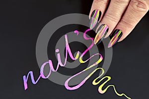 Multicolored striped nail design on long sharp shape with black lacquer. photo