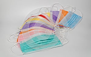 Multicolored surgical masks on white background. disposable medical face masks in different colors. Medical respiratory bandage