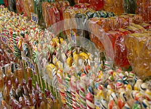 Multicolored sweet lollipops of different shapes of hearts and sticks