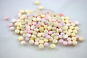 Multicolored tablets closeup with sofl natural shadows and reflection on white background