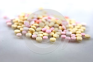 Multicolored tablets closeup with sofl natural shadows and reflection on white background