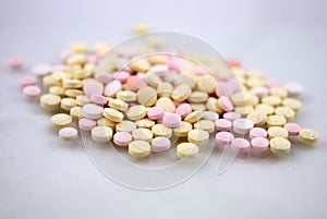 Multicolored tablets closeup with sofl natural shadows and reflection on white background