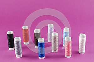 Multicolored Thread Reels on Purple Background