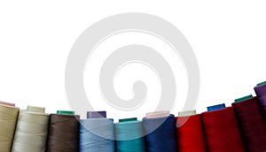 Multicolored threads isolated on a white background. Copy space. Sewing accessories.