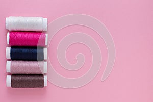 multicolored threads on a pink background. place for your mockup