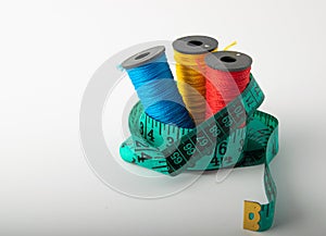 Multicolored threads, scissors and ruler.