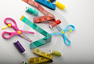 Multicolored threads, scissors and ruler.