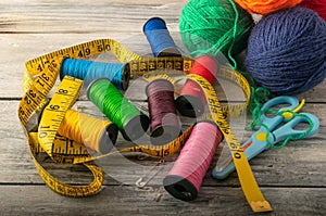 Multicolored threads, scissors and ruler.