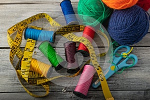 Multicolored threads, scissors and ruler.