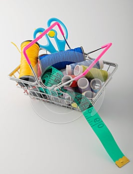 Multicolored threads, scissors and ruler.