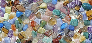 Multicolored tumbled crystal stones background photo