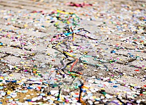 Multicolored wacky strings on the ground after mardi gras party