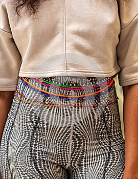Multicolored waist beads , Bebe, as outerwear on a young lady photo