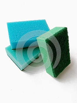 multicolored washing kitchen sponges with abrasive green scourer on white background