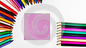 Multicolored wax Ñrayons with paper on white background with copy space. school concept