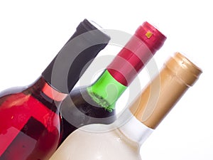 Multicolored wine bottles isolated on white