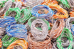 Multicolored wires entangled in many hanks. Abstract colorful background of electrical cables.  Random weaving of colored wire